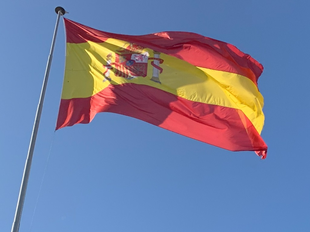 What are embassies and consulates - Spanish flag against blue sky