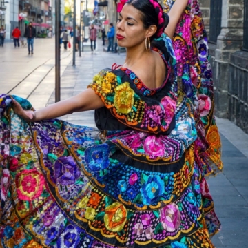 Malaga holidays 2024. Woman wearing a colorful flamenco dress.