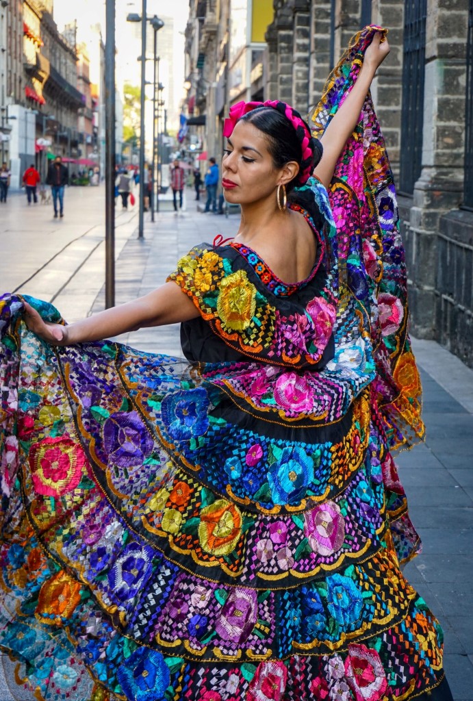 Malaga holidays 2024. Woman wearing a colorful flamenco dress.